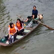 Rowboat on Tam Coc driven by an elderly Lady with her feet