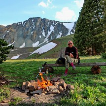 Alfred with a little campfire and 3651 meters high Chief Mountain
