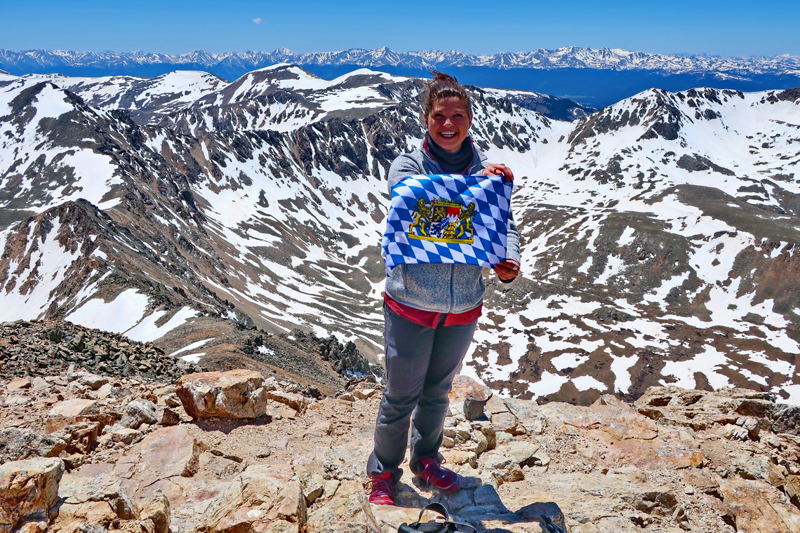 Girl from Colorado with Bavarian flag on Mount Democrat