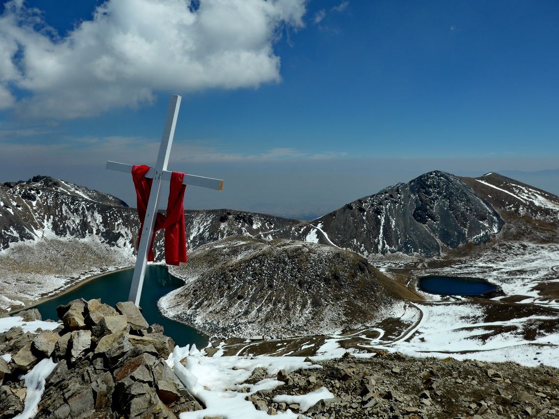 The cross on the eastern peak of Xinantecatl with Laguna del Sol and Laguna de la Luna