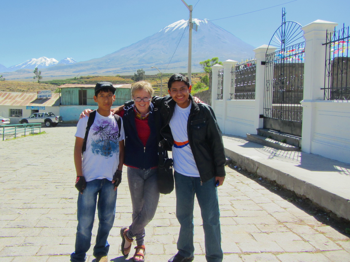 Marion with two boys of Chiguata. Nevado Chachani (left) and Volcan El Misti (center) in the background