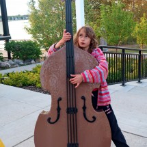 Rosemarie playing contrabass with Sylvan Lake in the background